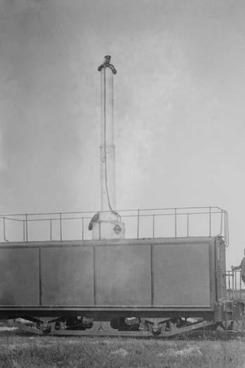 A Train Carries a man 10 stories aloft on what looks like a Chimney