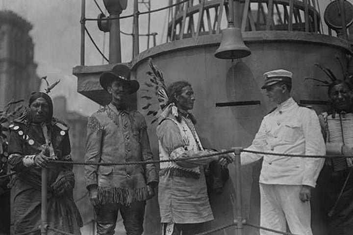 A War Bonneted Native American shakes hands with the Commander of the 'Recruit'
