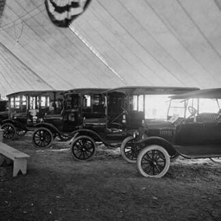 Automobiles on Display in Tent Under American Flag Banners #2