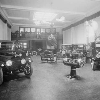 Automobiles on Display in Tent Under American Flag Banners