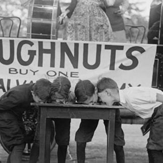 Boys Chow Down on a Table in a Donut Eating Contest