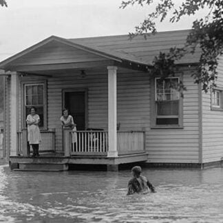 Children on porch of house surrounded by flood