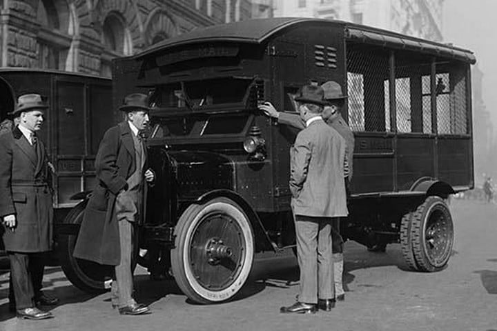 Delivery of New Mail Truck Inspected by four men