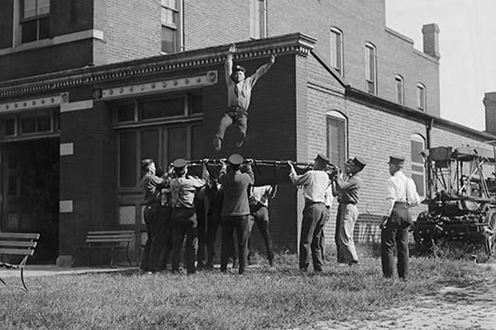 Firefighter Jumps into Net Held by Fellow Firemen