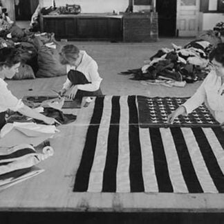 Flags laid out on cutting table to be sewn by Seamstresses who will make American ensigns during the period of the Great War
