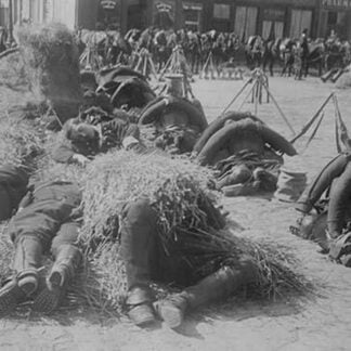 French soldiers in full pack bed down on straw after a long march
