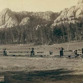 Full view of as train coming through the mountains in the West