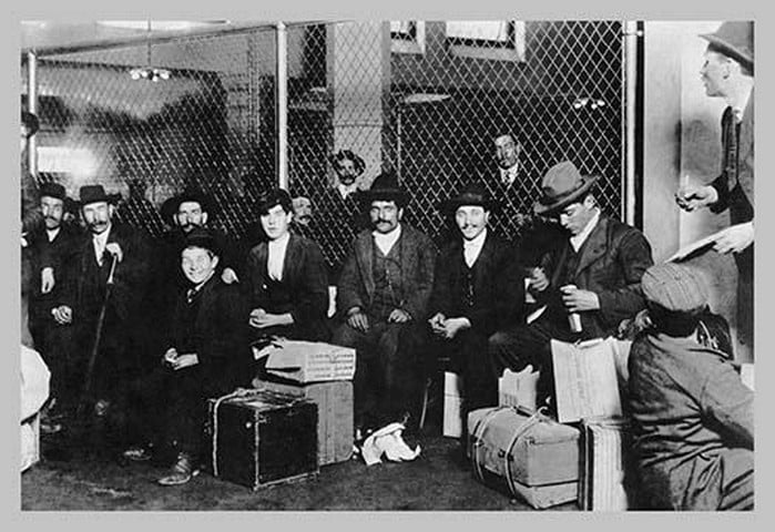 Immigrant Men Sitting at Ellis Island