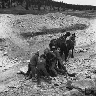 Loading boulder on stone boat by Dorothea Lange