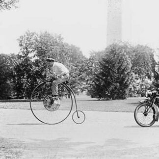 Motorcycle Cop Chases a Penny Farthing Velocipede Down a DC Street with Washington Monument in Background