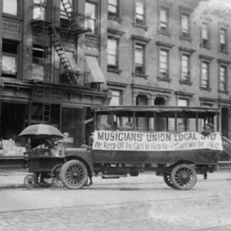 Musicians Union Truck parked by Hot Dog Vendor Cart sports large banner supporting the Transit Strike
