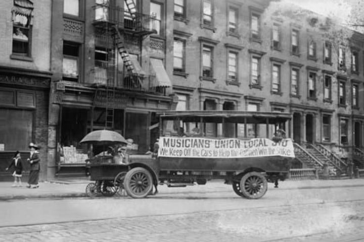 Musicians Union Truck parked by Hot Dog Vendor Cart sports large banner supporting the Transit Strike