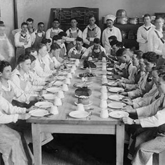 Naval Cadets sit at long table with bowls in front