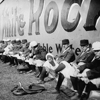 Philadelphia Americans Relax by sitting along the Center Field Fence at the Park