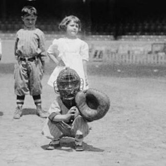 Pint sized Catcher awaits a pitch in Children's Baseball Game
