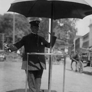 Policeman Directs traffic from underneath an umbrella in Newport