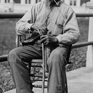 Portrait of an Male Ex-Slave Sitting in Chair & Smoking
