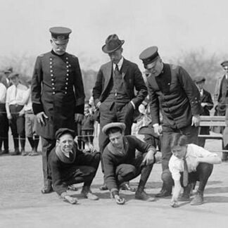 Three Young Boys Crouch in front of three men - the boys hold their marbles