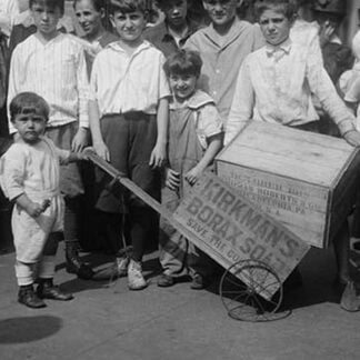 Toddler holds a small Soap Box Derby Vehicle