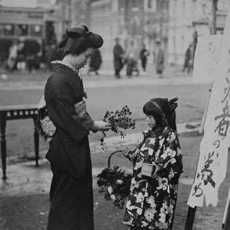 Toddler in front of Shop sign sells flowers to a kimono wearing young lady