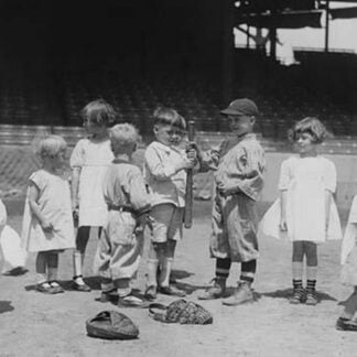 Toddlers on Baseball Field grasp a bat to select team members
