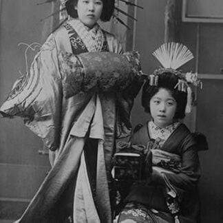 Two Young Beautiful Japanese Geishas in Ceremonial Costumes and Hairstyles of Ancient Japan with Kimono