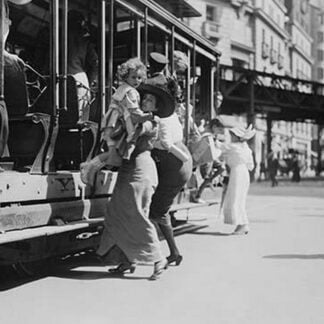 Woman lifts Child off of an open sided Trolley Car on New York's Broadway