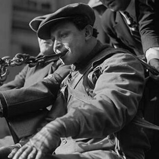 Young Man Pulls Wagon by a Chain in his Mouth; He is Harnessed