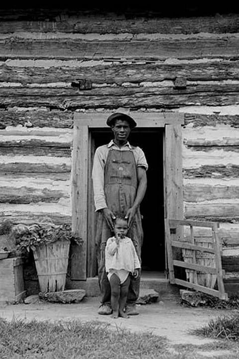 Young Sharecropper and His First Child by Dorothea Lange
